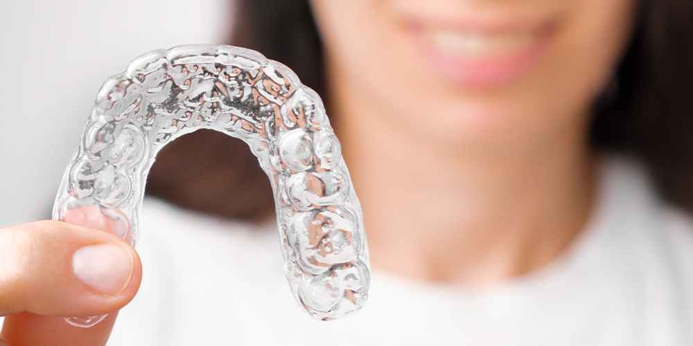 close up of a woman with transparent orthodontics