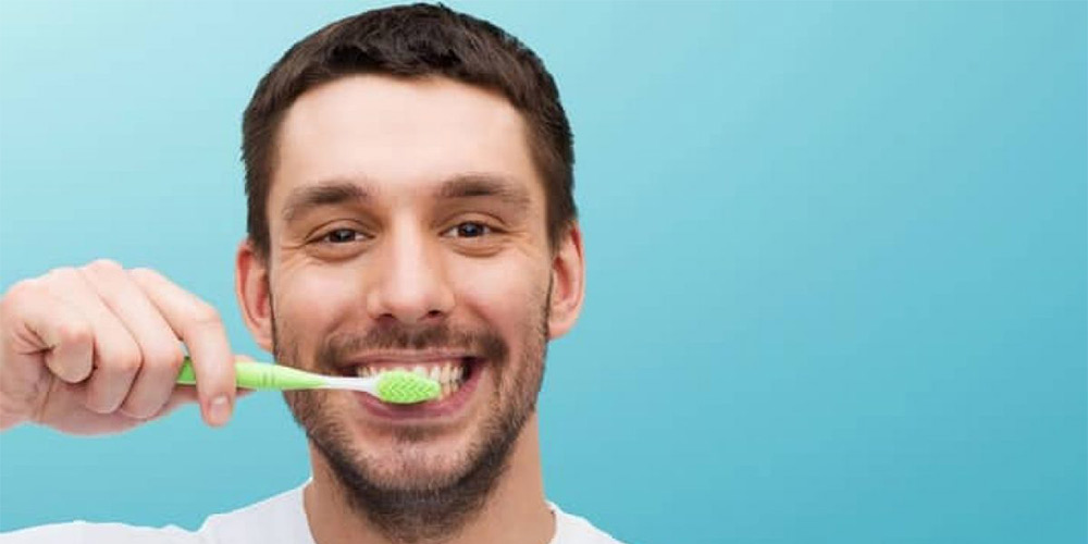 a man that brushing his teeth