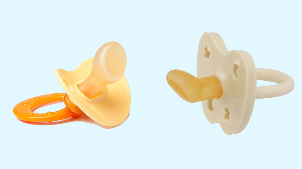 Picture of two orange and cream orthodontic pacifiers