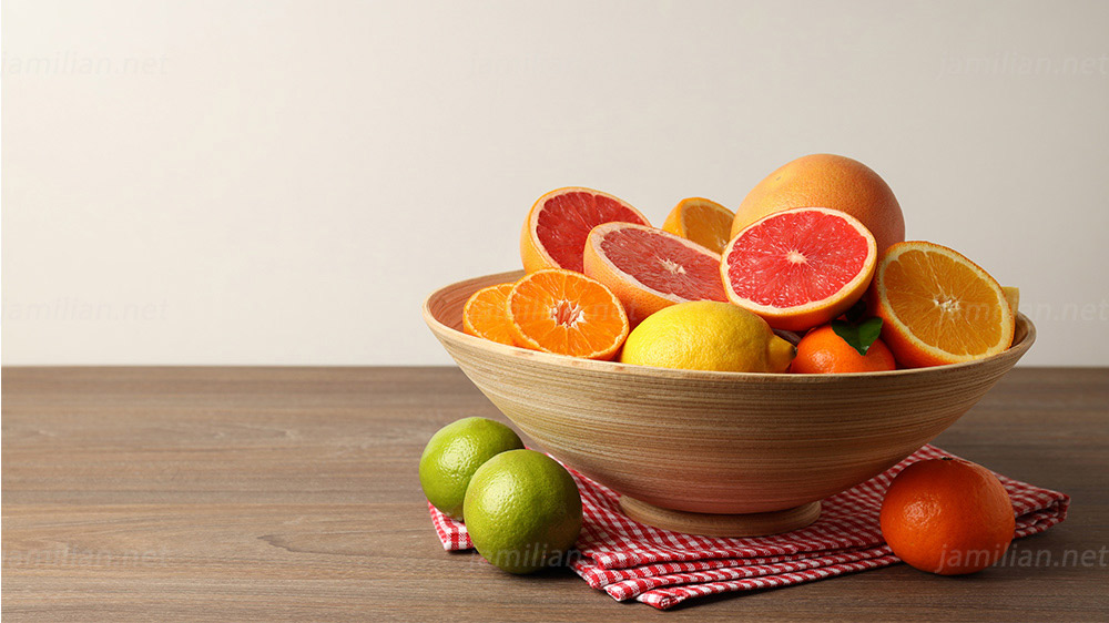 different citrus fruits on wooden table