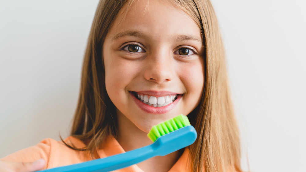 a girl with toothbrush